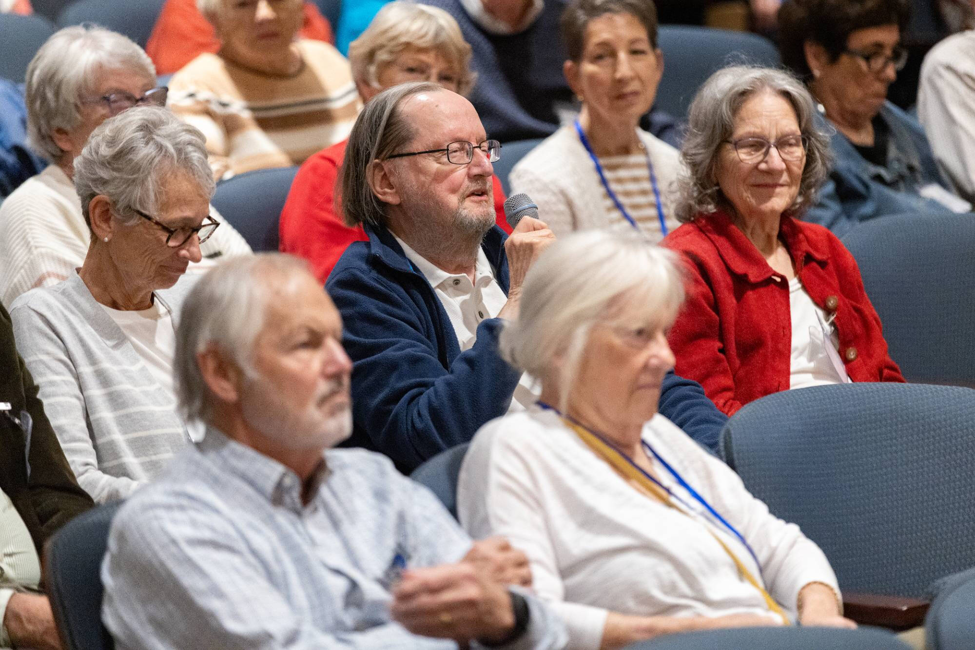 Grand Forum attendees listen on from the audience during a session.
